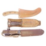 Three pilots' survival knives and scabbards, to include a Wilkinson Type D knife, an RAF curved