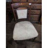 An Edwardian easy chair with inlaid decoration