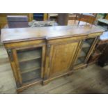 A 19th century walnut credenza having central door flanked by two glazed doors , width 66ins , depth