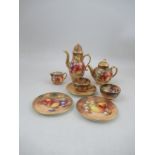 A collection of Royal Worcester miniatures tea items, all painted with fruit to a mossy background
