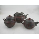 A chinese teapot, sugar bowl and jug applied with metal fret cut dragons by Ho Sheng