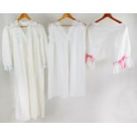 Early 20th century white cotton nightgown with delicate lace and blue ribbon neckline, together with