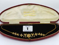An Edwardian gold and seed pearl flower necklace, set in 9ct yellow gold, length 38cm, cased.