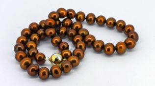 A necklace strung with chocolate coloured freshwater cultured pearls, fitted with a 9ct white and