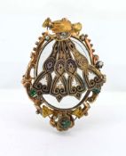 An antique gold pendant, featuring an articulated fan suspended above by a gloved hand, set with