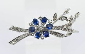 A diamond and sapphire floral spray brooch, set in white metal (possibly 14k?), approx 10.9g.