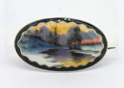 A silver and enamel set brooch, landscape scene, possibly Norwegian (damage to enamel).
