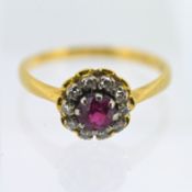 A ruby and diamond set cluster ring, set in 18ct yellow gold, size O.