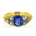A Victorian sapphire and diamond ring, claw set to the centre with an oval-cut sapphire and set each