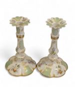 A pair of Halcyon Days enamel candlesticks decorated with flowers in the classical manner, 17cm