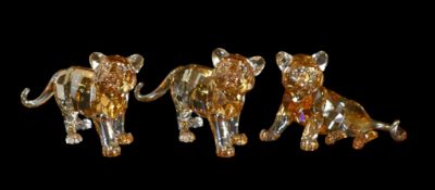 Three Swarovski Amber Crystal Tiger Cubs (1016677), (1051686), (1016678) retired 2010, designed by