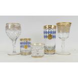 De Lamerie, heavily gilt decorated wine glasses, cocktail glass, glass teacup and tumbler with a