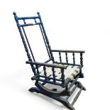 Antique American oak bobbin turned rocking chair with seat webbing visible. H102cm x W54cm x D54cm