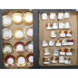De Lamerie Fine Bone China, a selection of heavily gilt coffee cans & saucers in varied colourways &