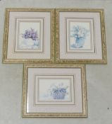 Three framed & mounted behind glass prints depicting floral vases and baskets. measures:- 34cm