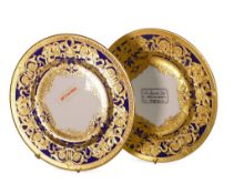 De Lamerie Fine Bone China, a pair of heavily gilt plates on blue. Made in England (2)