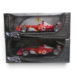 Hot Wheels 1:18th scale diecast F1 cars, Michael Schumacher, Ferrari F2002 & F2003-GA, boxed. (2)