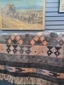 A Kelim rug having diamond design central panel, brown ground, 191 x 100 cms