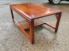A rectangular mahogany crossbanded coffee table with moulded top on square chamfered legs with