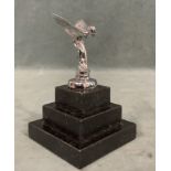 A Rolls Royce chromed Spirit of Ecstasy car mascot, mounted on a square stepped marble plinth. (