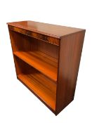 A reproduction mahogany open bookcase with plain panelled frieze above an adjustable shelf and