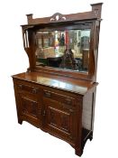 An art nouveau mahogany mirror-back sideboard with pierced heart motifs above a shelf and bevelled