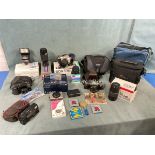 Six cameras, manuals and other equipment, some boxed - two Canon 35mm SLR cameras, Konica and