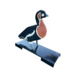 A giant Lego brick statue of a red-breasted goose, the bird mounted on a rectangular metal