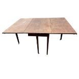 A Georgian mahogany dining table with two rule-jointed drop leaves, the table formerly having