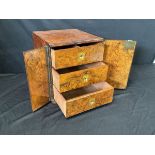 A Victorian burr walnut table cabinet with rectangular ebony banded top above a pair of doors