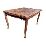 A French oak parquetry dining table having scalloped top with two drawer leaves, the shaped