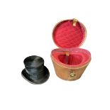 A Victorian leather hat box with oval cover, having tapering body and quilted padded lining,