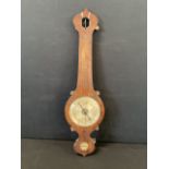 A Victorian rosewood wheel barometer case by Harmer of Beccles with engraved silvered dial above a
