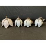 A set of three Edwardian style brass and marbled glass flowerhead form pendant lights, suspended