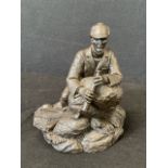 Tom Mackie, a Heredities bronze patinated deer stalker leaning on a rock with his telescope,