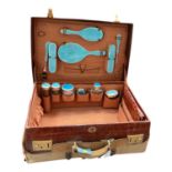 Early 20th century crocodile skin travelling case with silver mounted and blue enamel fittings