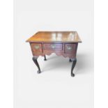 A good George III oak lowboy with inlaid star and crossbanded top, three drawers with original brass
