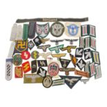 Group of assorted cloth Nazi German uniform badges.