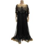 1911-1912 Black silk and silk-crepe dress with black net overlay. Elaborate black beading and sequin