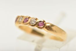 A YELLOW METAL GEM SET RING, set with three circular cut rubies and two colourless cubic zirconia,