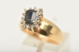 A SAPPHIRE AND DIAMOND CLUSTER RING, set with a rectangular shape sapphire, bordered by round