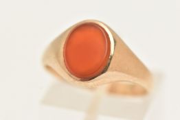A 9CT GOLD CARNELIAN SET SIGNET RING, of an oval form, leading onto a polished band, hallmarked