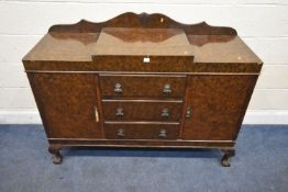 AN ART DECO WALNUT SIDEBOARD, with a raised back and central section, fitted with two cupboard doors