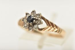 A 9CT GOLD CLUSTER RING, of a floral form, set with a central blue sapphire in a surround of