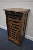 A CRUSADER OAK TAMBOUR FRONT FILING CABINET, with nine slides, width 56cm x depth 55cm x 112cm,