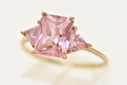 A 9CT GOLD PINK CUBIC ZIRCONIA THREE STONE RING, set with a central rectangular cut stone flanked