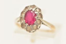 A 9CT GOLD CLUSTER RING, of an oval form, set with a central oval cut synthetic ruby, in a