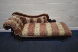 A VICTORIAN CHAISE LONGUE, with a scrolled end, with stripped and foliate upholstery, raised on