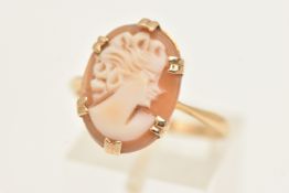 A YELLOW METAL CAMEO RING, carved oval shell cameo depicting a lady in profile, six double claw