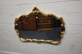 A MODERN GILT RESIN WALL MIRROR, with scrolled details, width 123cm x height 87cm, condition report: